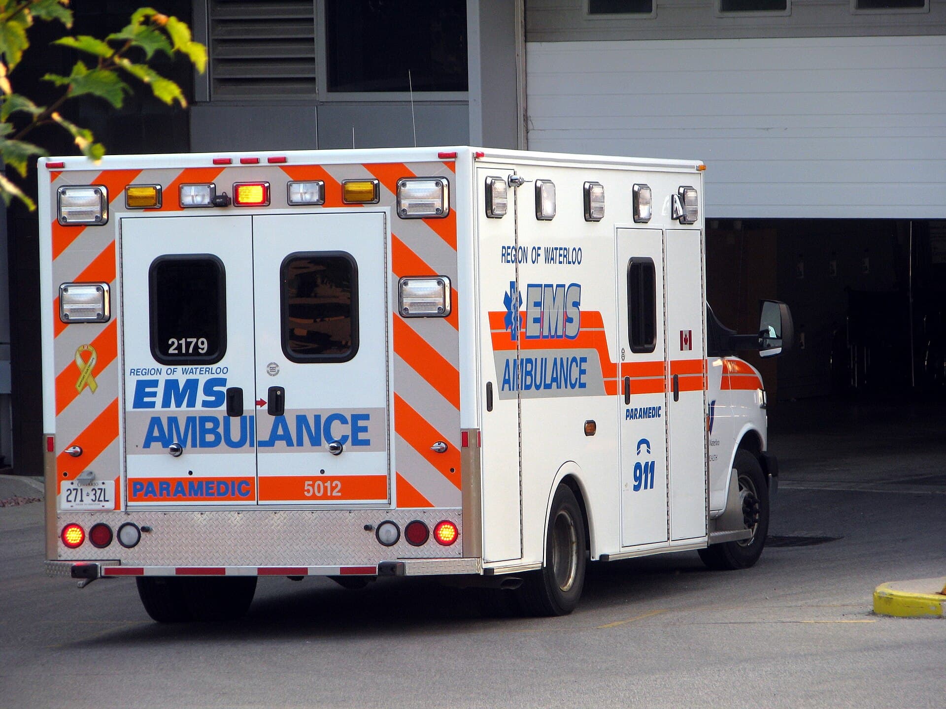 An ambulance parked on an Ontario street, seen from the rear